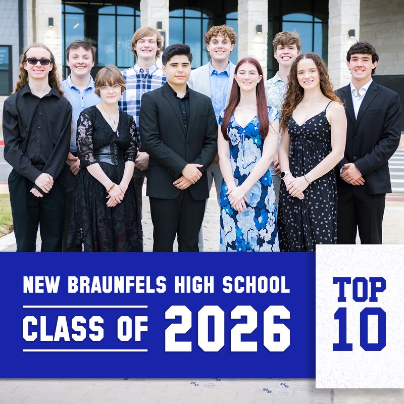 Ten high school seniors in formal attire pose outside a building with a blue banner reading New Braunfels High School Class of 2026 Top 10.